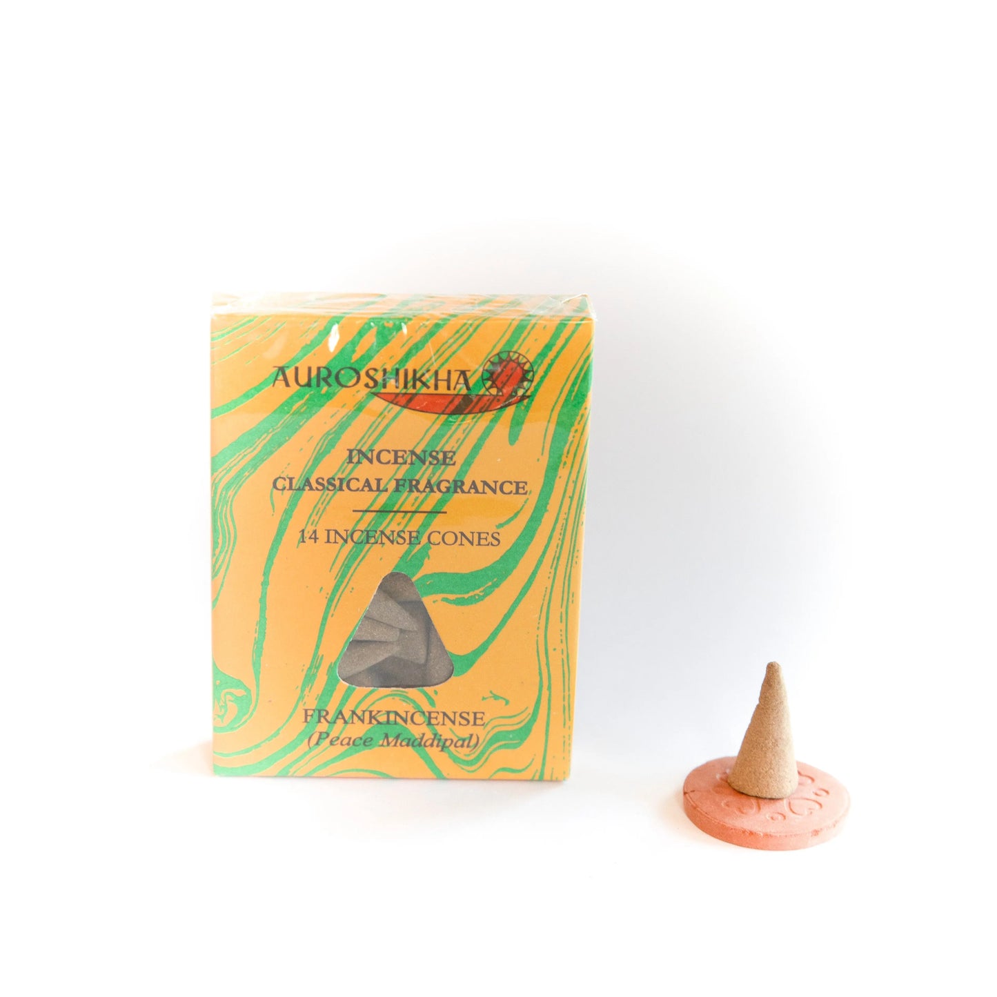 Auroshikha Frankincense marbling cone with Artschatz branding beside a lit cone on a pink holder. - Frankincense