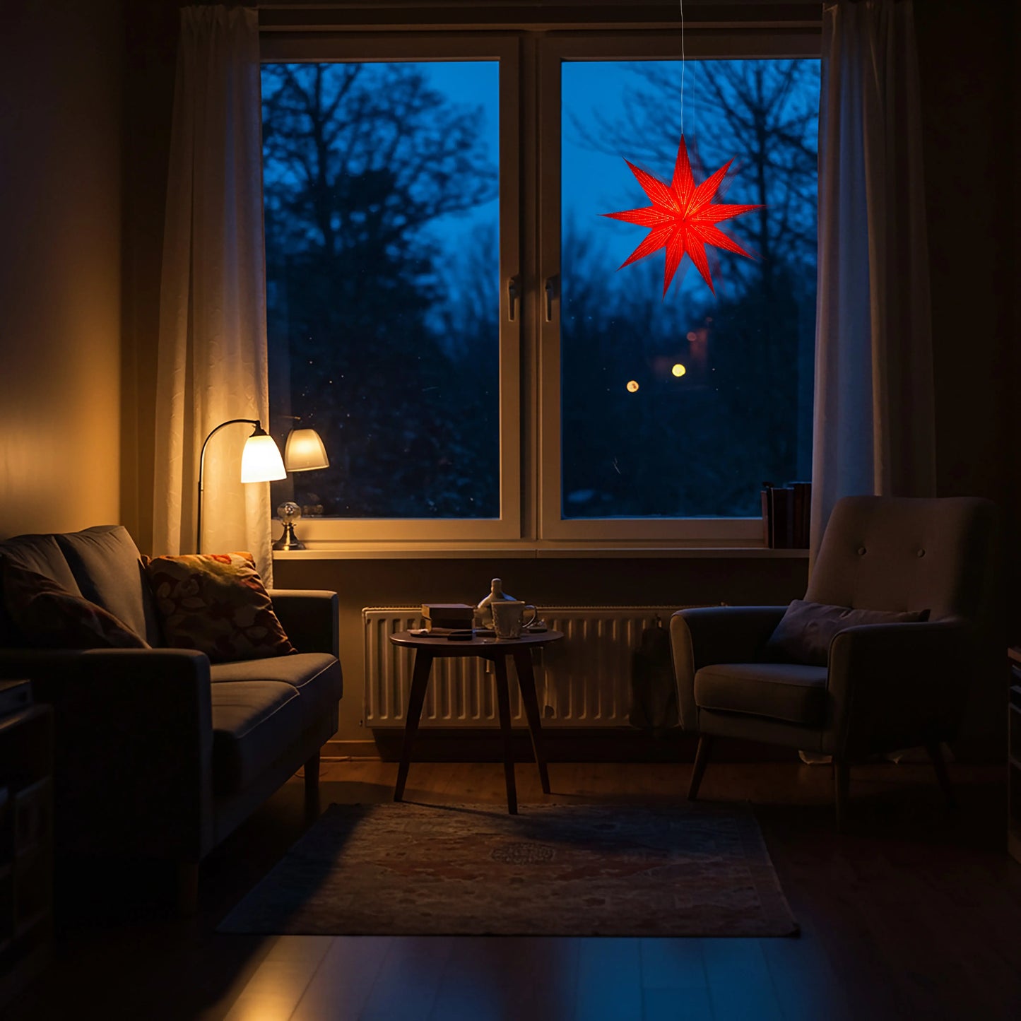 Red 18-inch 9-point Artschatz paper star lantern glowing in window at dusk. - Dottie ~ 9 Pointer, 18 inch, Red