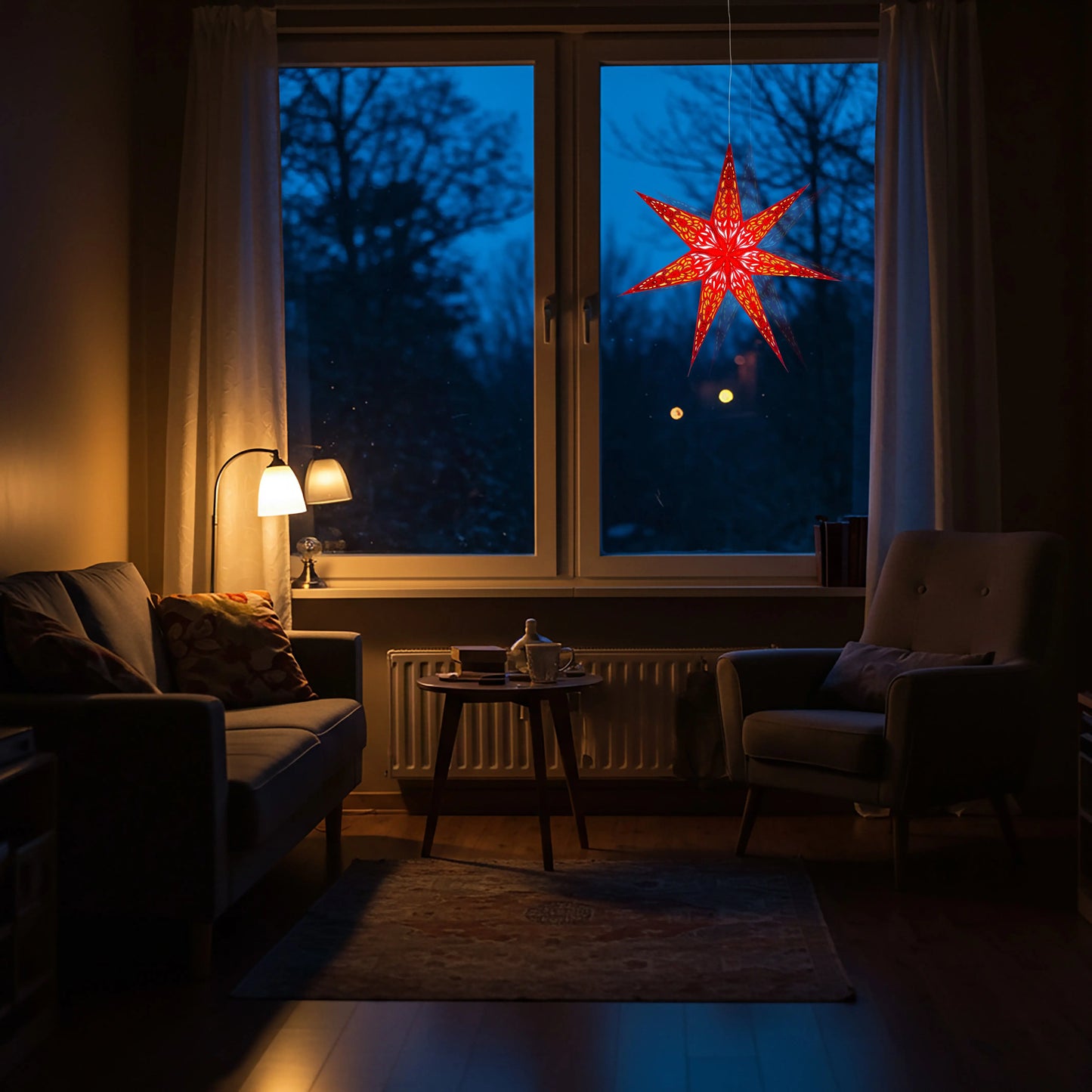 Red Artschatz 23" 7-point illuminated paper star hanging in window at dusk. - Nigella 7 Point 23" Red