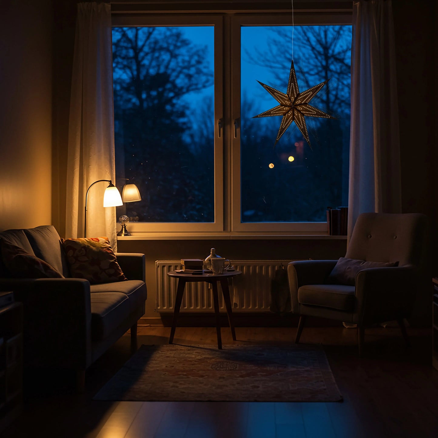 Black Artschatz Prima Dottie 7 Pointer 23-inch paper star illuminated in cozy living room window at dusk. - Prima Dottie 7 Pointer 23 inch Black