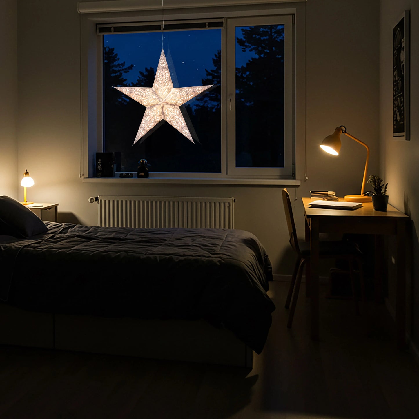 White 24-inch Artschatz 5-point paper star with glitter hanging in bedroom window at night. - Phoenix 5 Pointer 24 inch White w/ Glitter