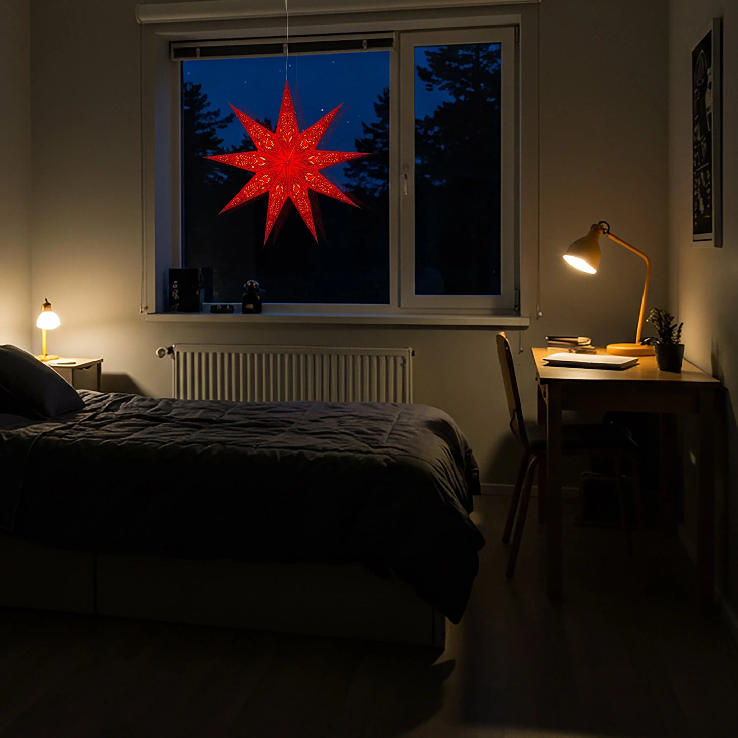 Red 25-inch Artschatz Phoenix 9-point paper star glowing in window at night. - Phoenix 9 Point 25" Red
