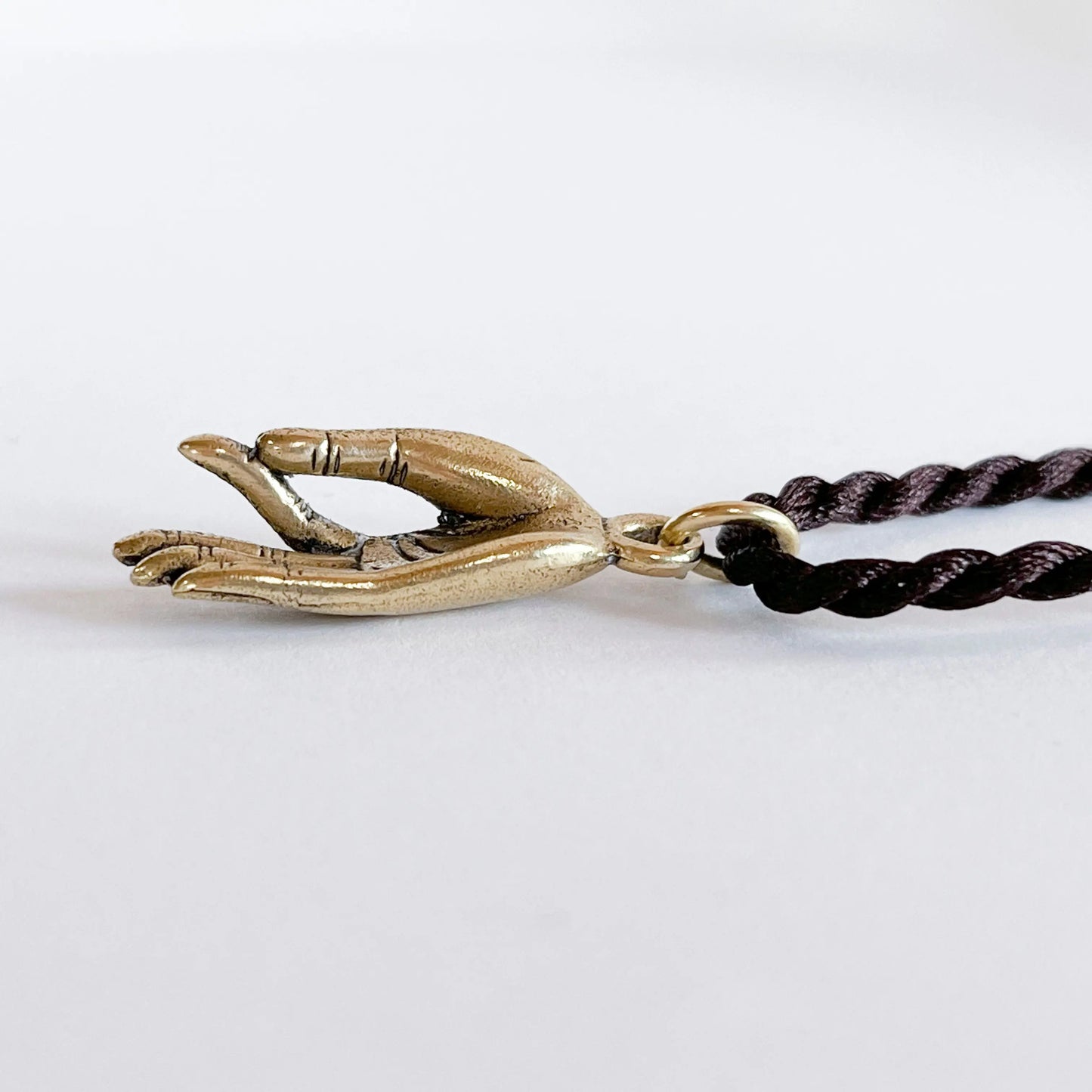 Brass Gyan Mudra Buddha hand pendant on dark braided Artschatz cord necklace. - Gyan Mudra Buddha Hand
