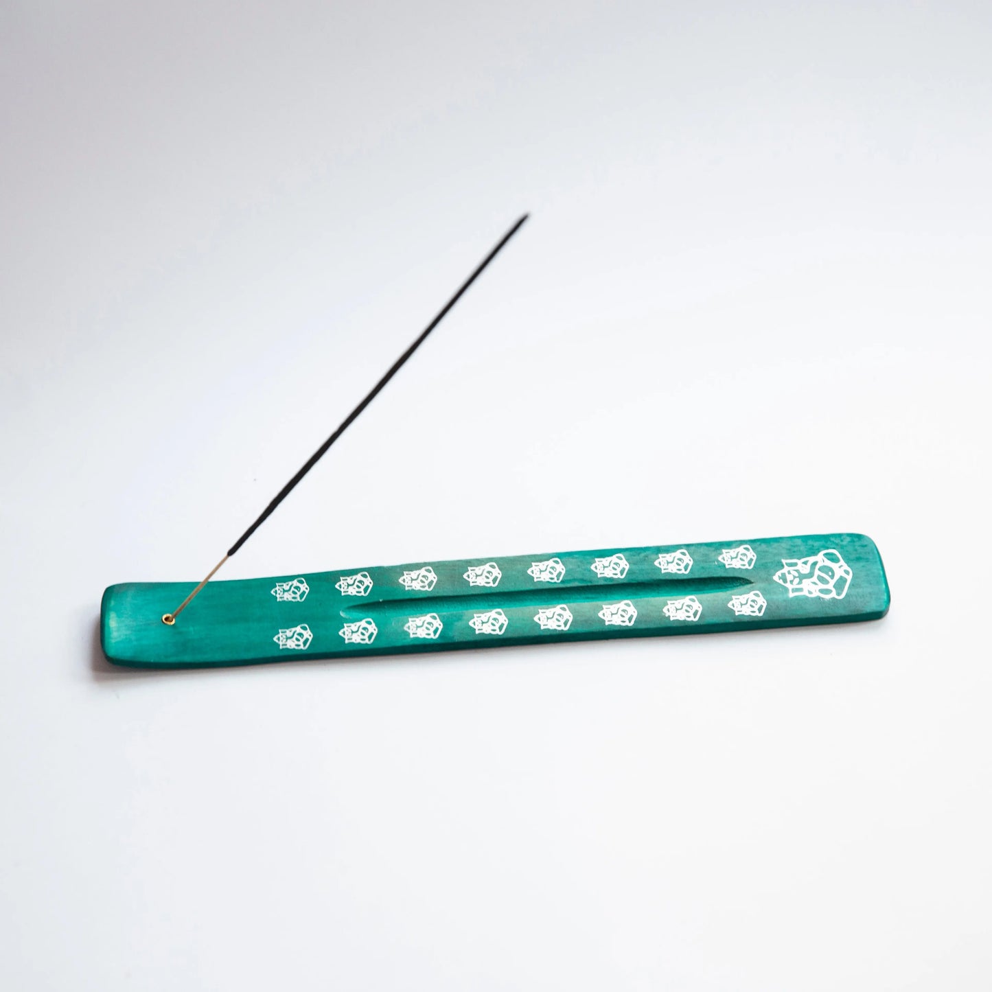 Green Artschatz Emerald Ganesh incense holder with white decorative patterns and incense stick. - Emerald Ganesh