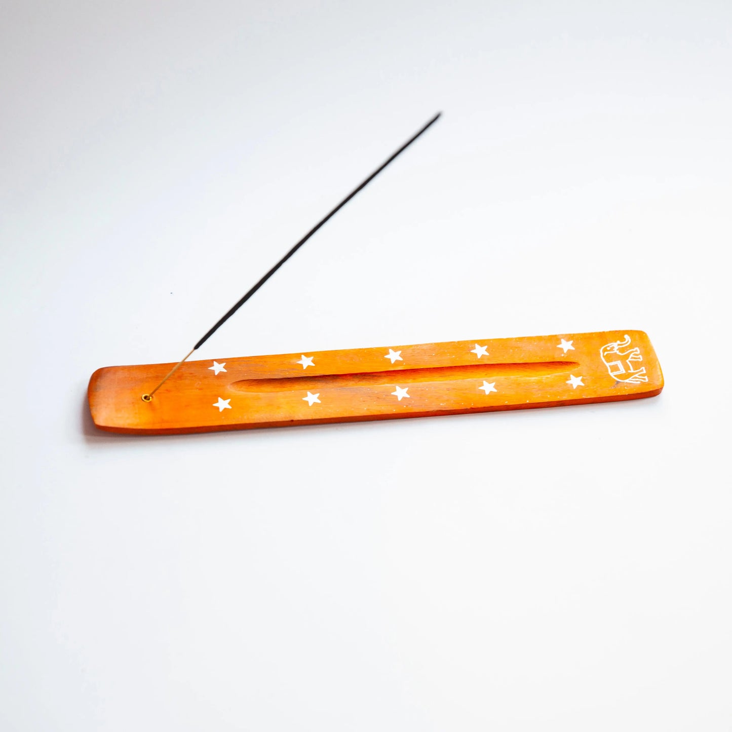 Orange Artschatz elephant-shaped incense holder with white stars and stick inserted. - Orange Elephant with Stars
